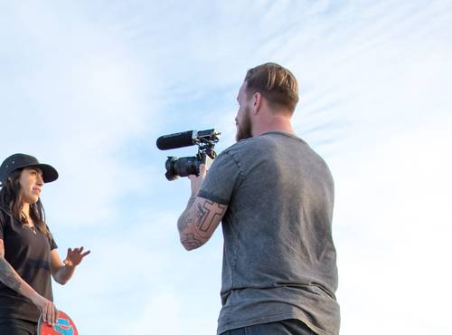 Skateboarder being interviewed under a bright sunny sky with inset of the F1's easy-to-read LCD screen