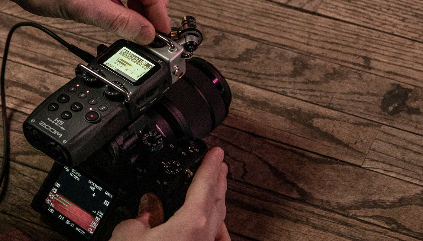 Videographer adjusting settings on H5. H5 mounted to DSLR camera.