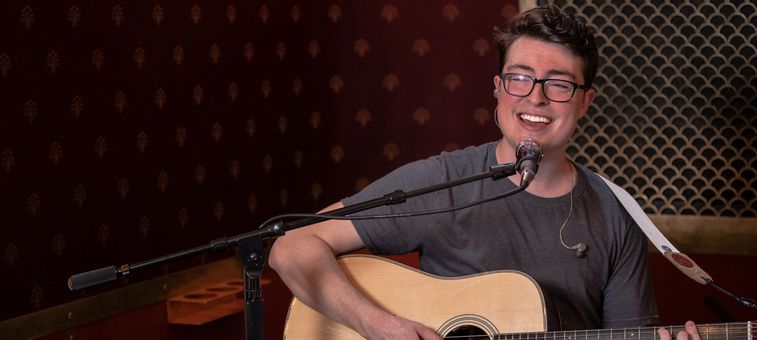 Person Playing Guitar with microphone
