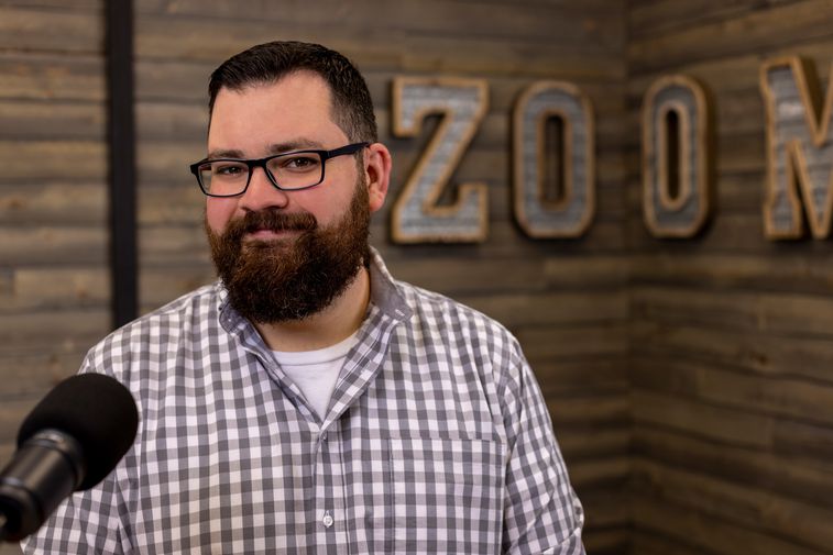 Samuel Greene standing with various Zoom products