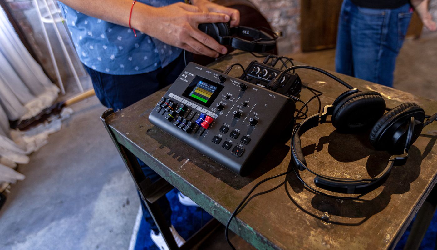 The R12 MultiTrak with headphones and musicians