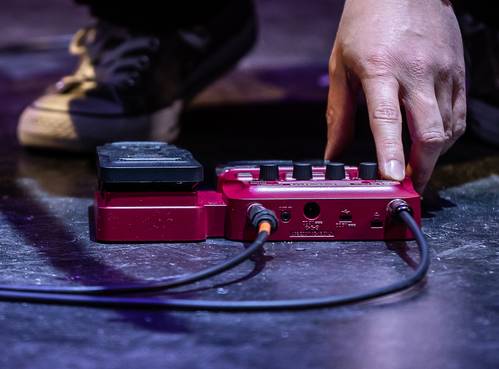 bassist using pedal on floor