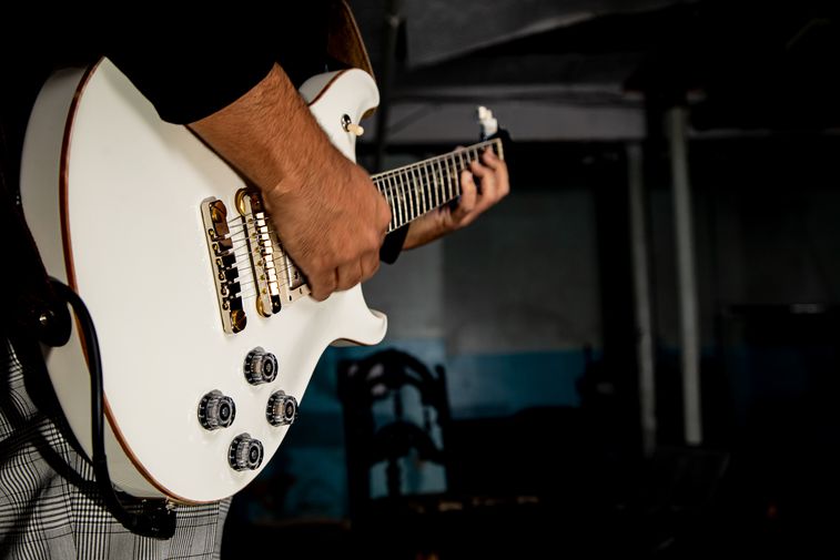 Ricardo playing a white Paul Reed Smith