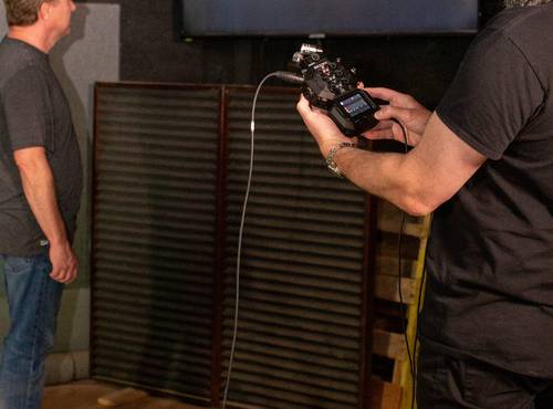 Foley artists creating sounds while engineer records