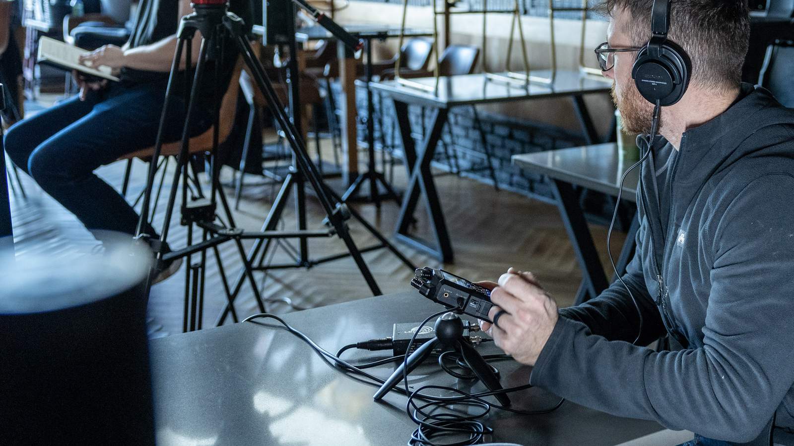 Recording engineer using headphones to monitor the sound being recorded with H4essential