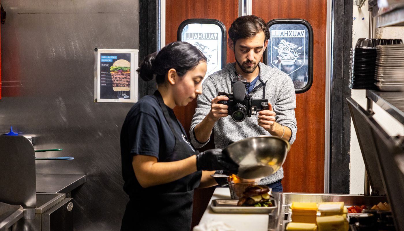 Videographer using the M3 with his camera rig to capture the sounds of a chef in a kitchen