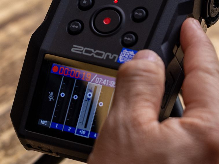 Using the mixer button and adjustment wheel to adjust track levels