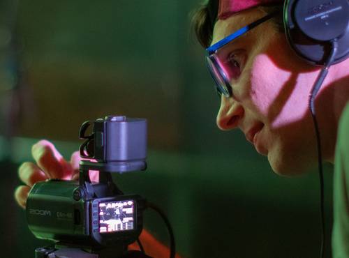 Videographer monitoring sound on the Q8n-4K