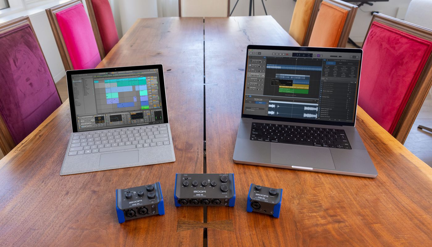 AMS Series on table with a MacBook Pro and a Windows Surface
